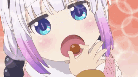a girl with purple hair and blue eyes is eating a donut from her hand .