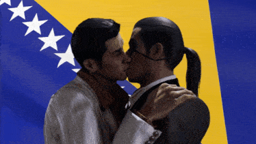 two men kissing in front of a yellow and blue flag with stars