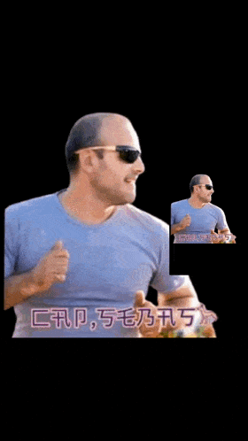 a man wearing sunglasses and a grey shirt is pointing at something