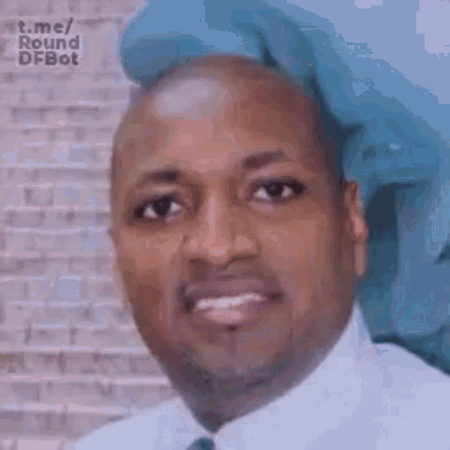 a man in a white shirt and tie is smiling .