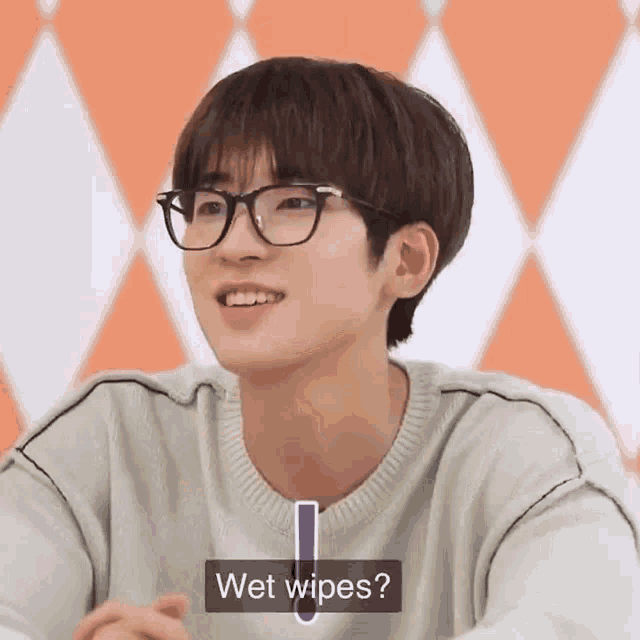 a young man wearing glasses and a sweater is asking if wet wipes are available .