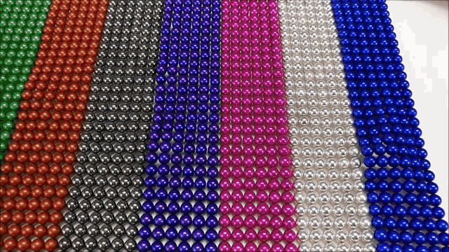a bunch of different colored beads on a table