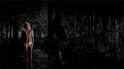 a man and a woman hugging each other in a dark room .