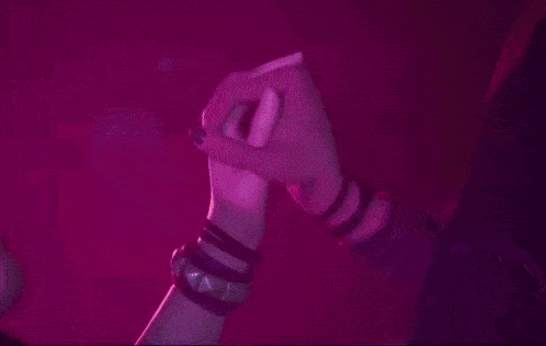 a man and a woman are kissing in a dark room .