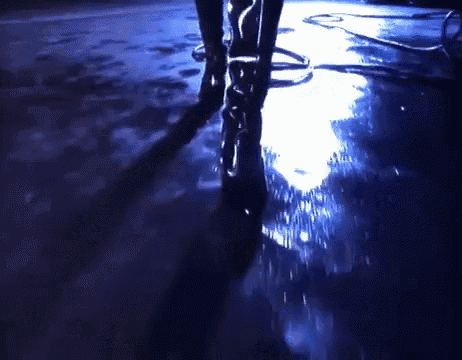 a person 's feet are visible in a dark room