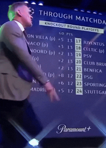 a man in a suit and tie stands in front of a screen that says through matches