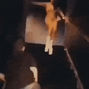 a blurry picture of a naked woman standing on a stage .