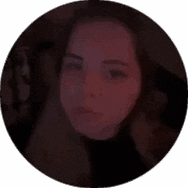 a close up of a woman 's face in a circle with a dark background .