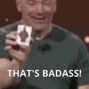 a man holding a card that says " that 's badass " on it