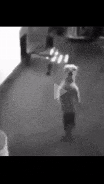 a black and white photo of a dog standing on its hind legs .