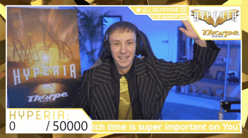 a man wearing headphones stands in front of a hyperia sign