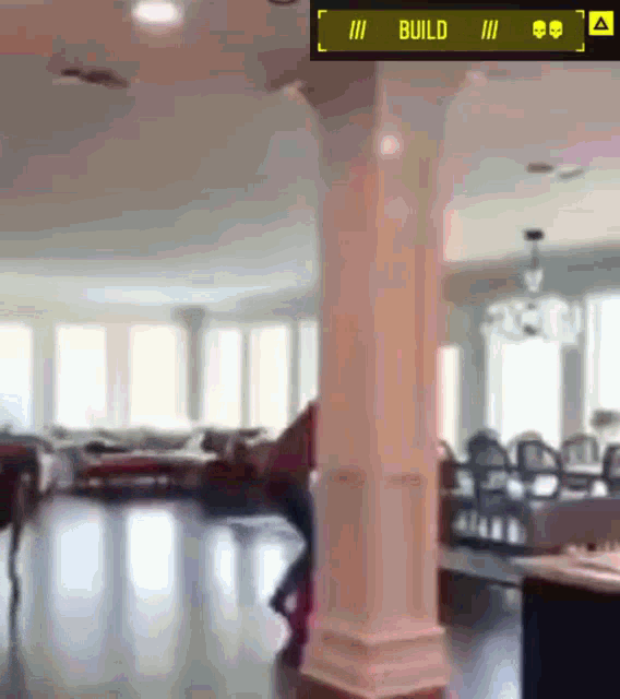 a blurred image of a living room with a yellow sign that says build
