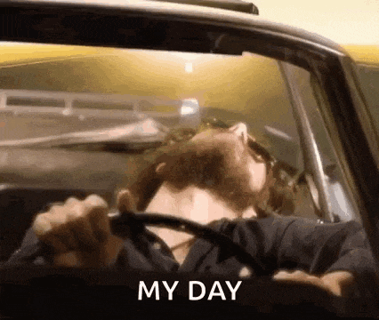 a man is driving a car with his eyes closed and the words `` my day '' written on the bottom .