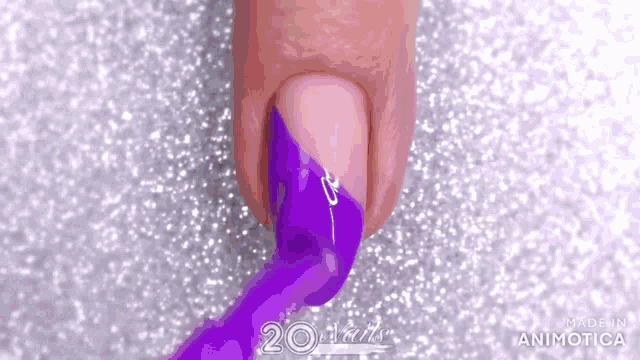 a close up of a person 's nail with purple nail polish .