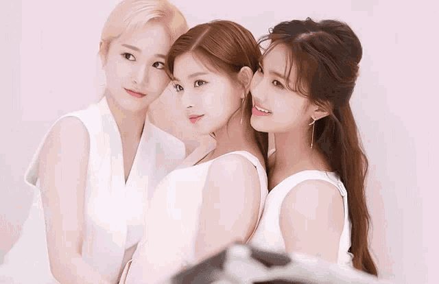 three women standing next to each other with their arms crossed