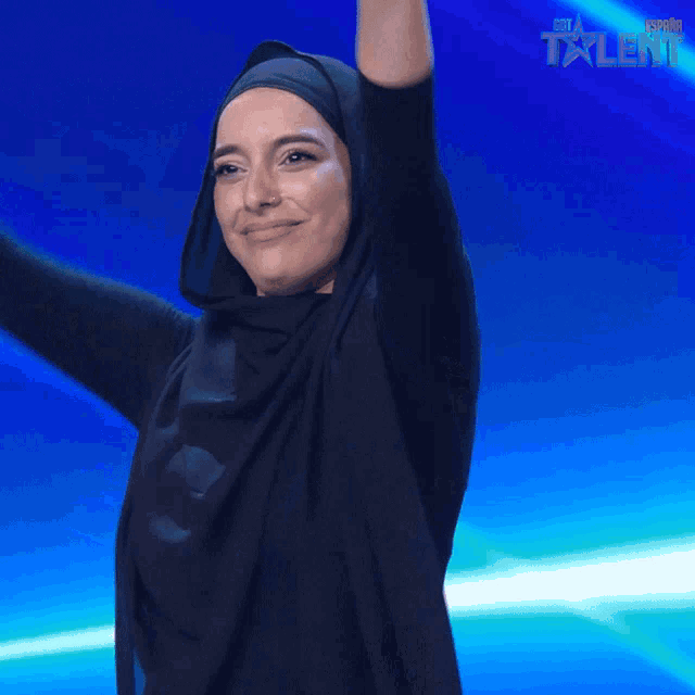 a woman in a hijab singing into a microphone with the words love you below her