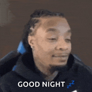 a man is sitting in a chair with his eyes closed and says good night .