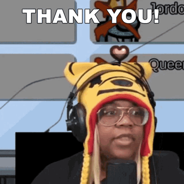 a woman wearing a tiger hat and headphones is saying thank you