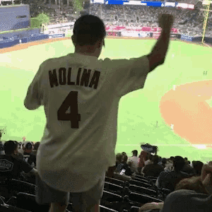 a man wearing a white jersey with the number 4 on it