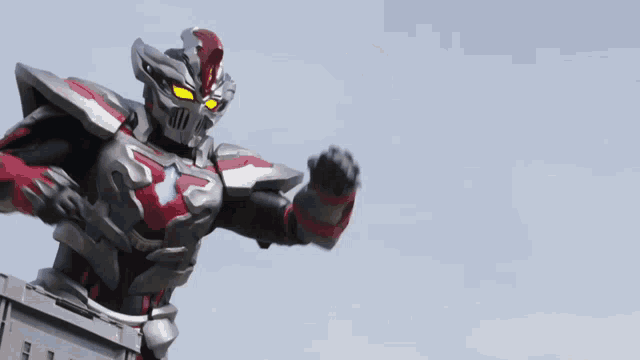 a robot with red and black armor and a helmet is flying through the air
