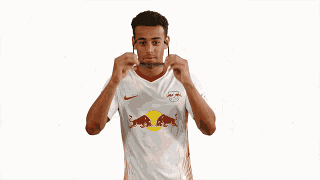 a man wearing sunglasses and a white shirt with red bulls on it