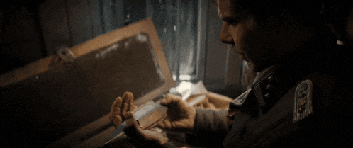 a man in a dark room looking at something
