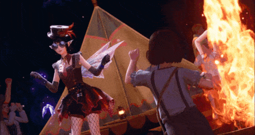 a girl in a fairy costume is dancing in front of a campfire