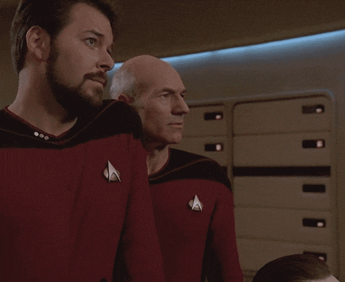 a man in a red shirt with a star trek logo on the back