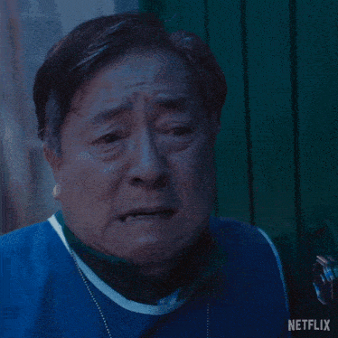 a man is wearing a blue vest with netflix written on it