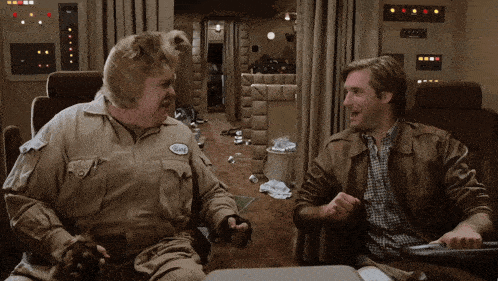 a man with a name tag that says burt sits with another man
