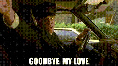 a man in a suit is driving a car with the words `` goodbye , my love '' written on the bottom .