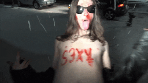 a naked person with the word sexy painted on their chest