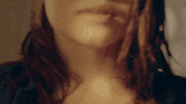 a close up of a woman 's face with a blurred background