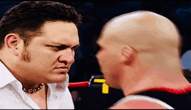 two bald men are looking at each other in a ring