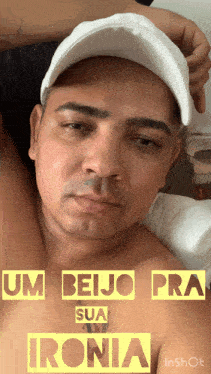 a shirtless man wearing a white hat with the words um beijo pra sua ironia on the bottom right