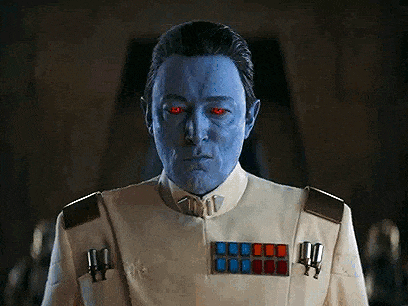 a man with a blue face and red eyes is wearing a white uniform