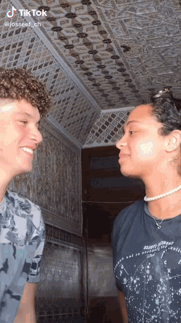 two men are looking at each other in a hallway with a tiktok watermark