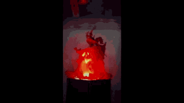 a red light is shining in the dark in a blurry photo .