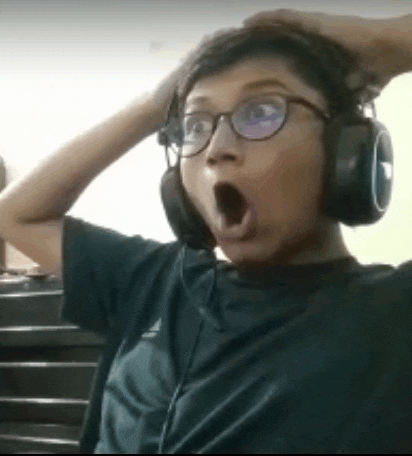 a young boy wearing headphones and glasses is making a funny face .