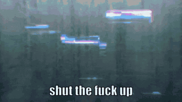 a blurry picture with the words shut the fuck up