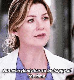 a woman in a white jacket and blue shirt says not everybody has to be happy all the time