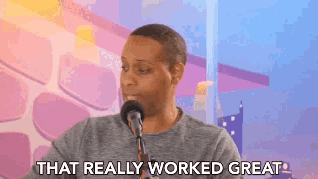 a man speaking into a microphone with the words that really worked great below him