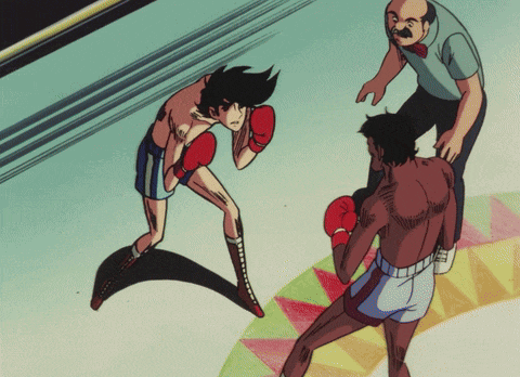 a man in boxing gloves is standing next to another man in boxing shorts