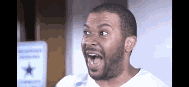 a man with a beard is making a surprised face with his mouth open