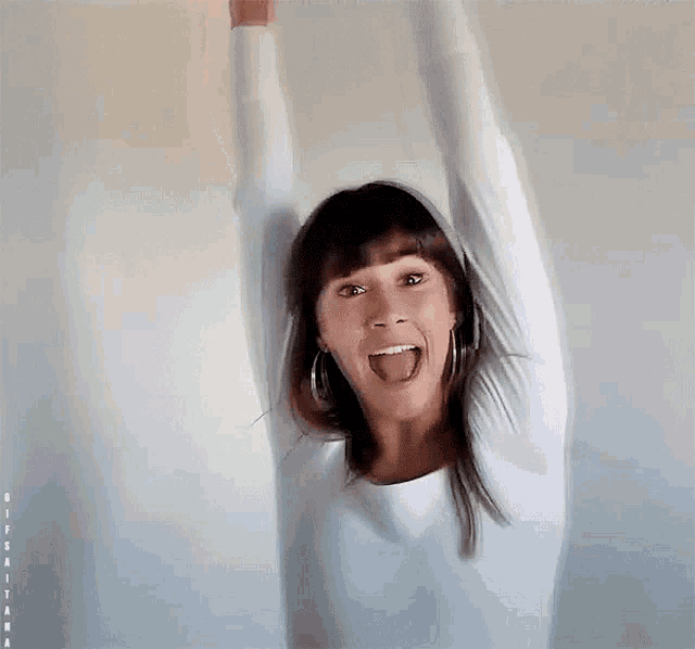 a woman with her arms in the air and her mouth open