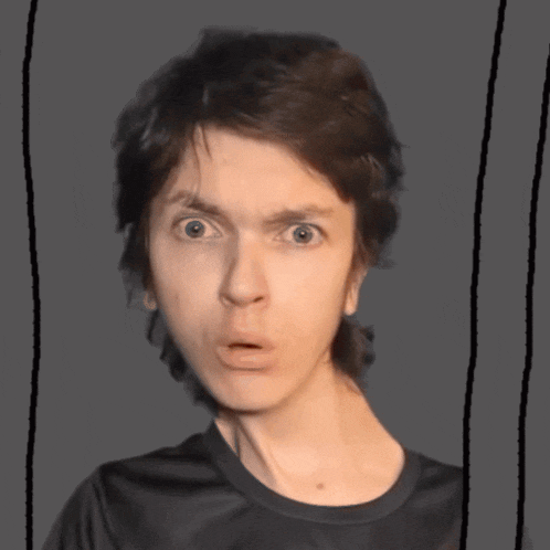 a close up of a person 's face with a surprised look on their face