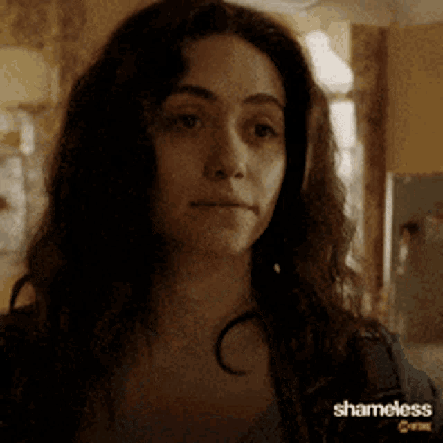a close up of a woman 's face with the word shameless on the bottom right