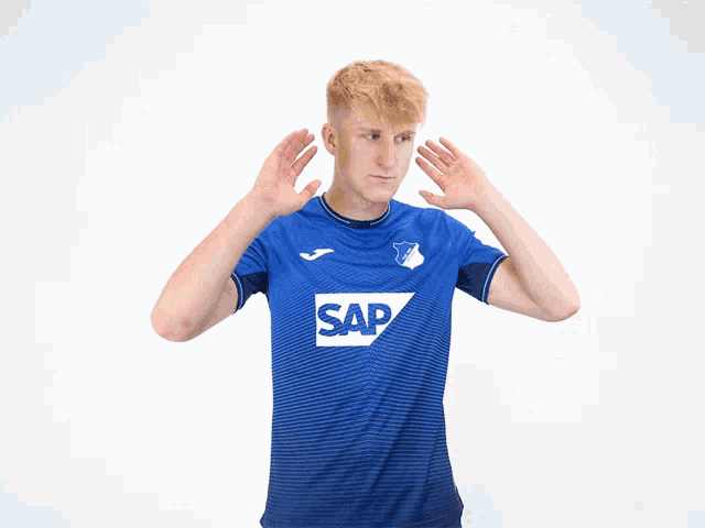 a man wearing a blue shirt with the word sap on the front