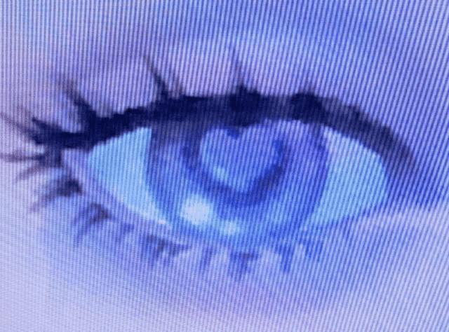 a close up of a blue eye on a purple background
