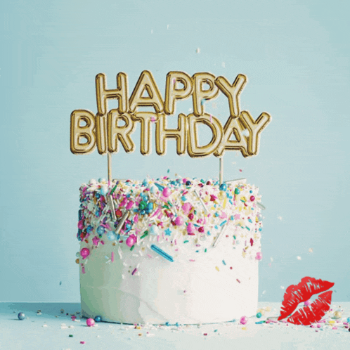 a cake with sprinkles and a happy birthday candle